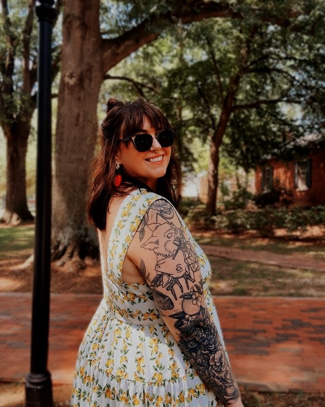 Jessa in a yellow floral dress under the trees